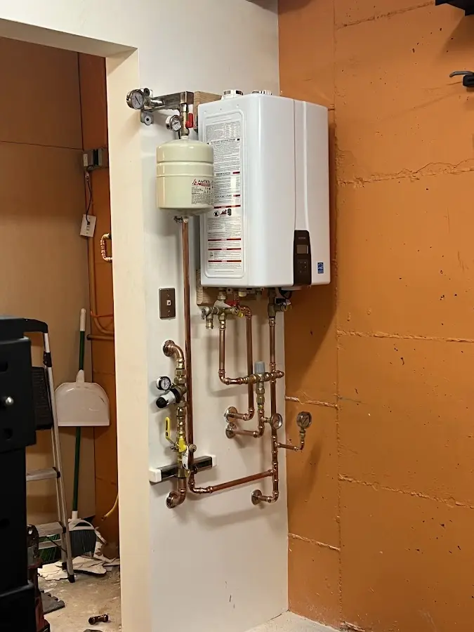 Plumbing technician inspecting water heater connections in Viera West